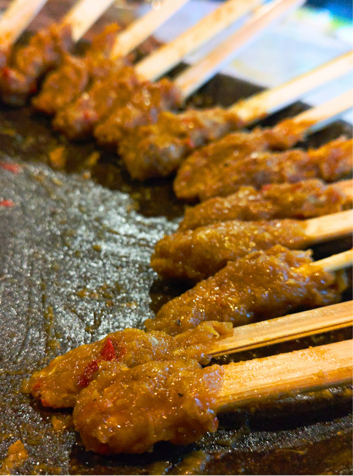 Foto dekat sate lilit yang belum dimasak di atas cobekan.